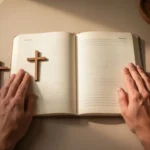 Quiet morning prayer with journal and cross beside resting hands