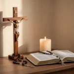 Prayer corner with rosary, crucifix, candle, and open Bible