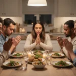 Family praying together around a warmly lit kitchen table