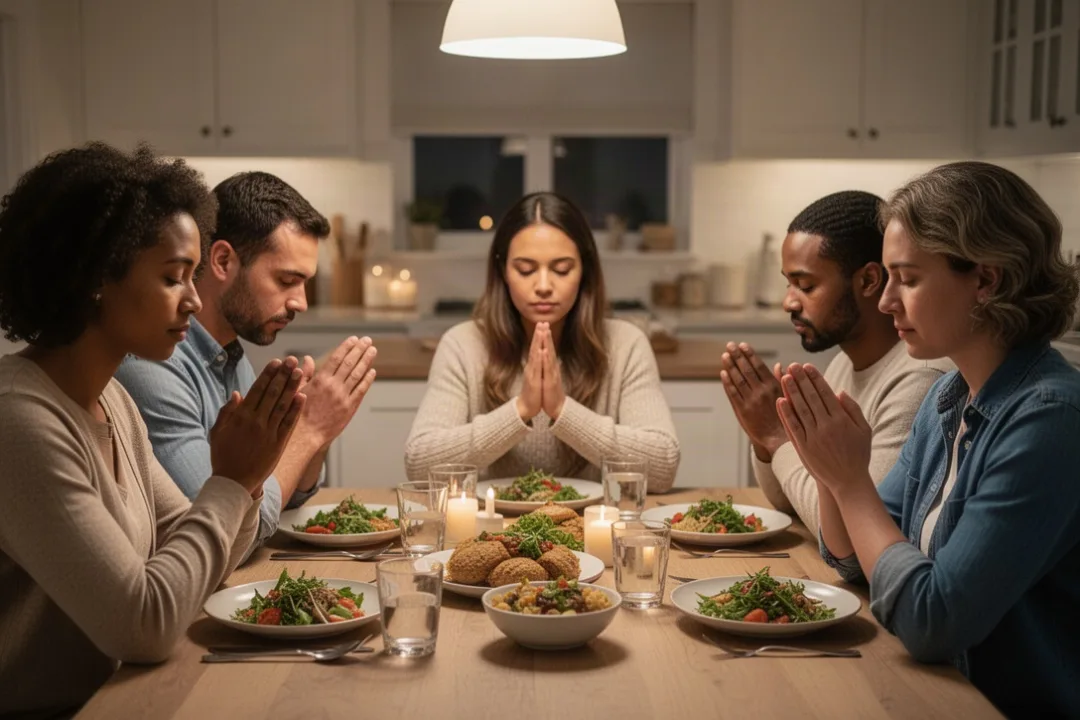 Family praying together around a warmly lit kitchen table